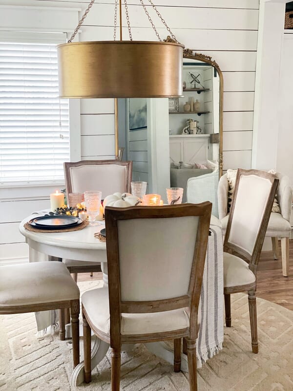 Light your breakfast nook with fixtures that share some similarity to other fixtures in the sightline.