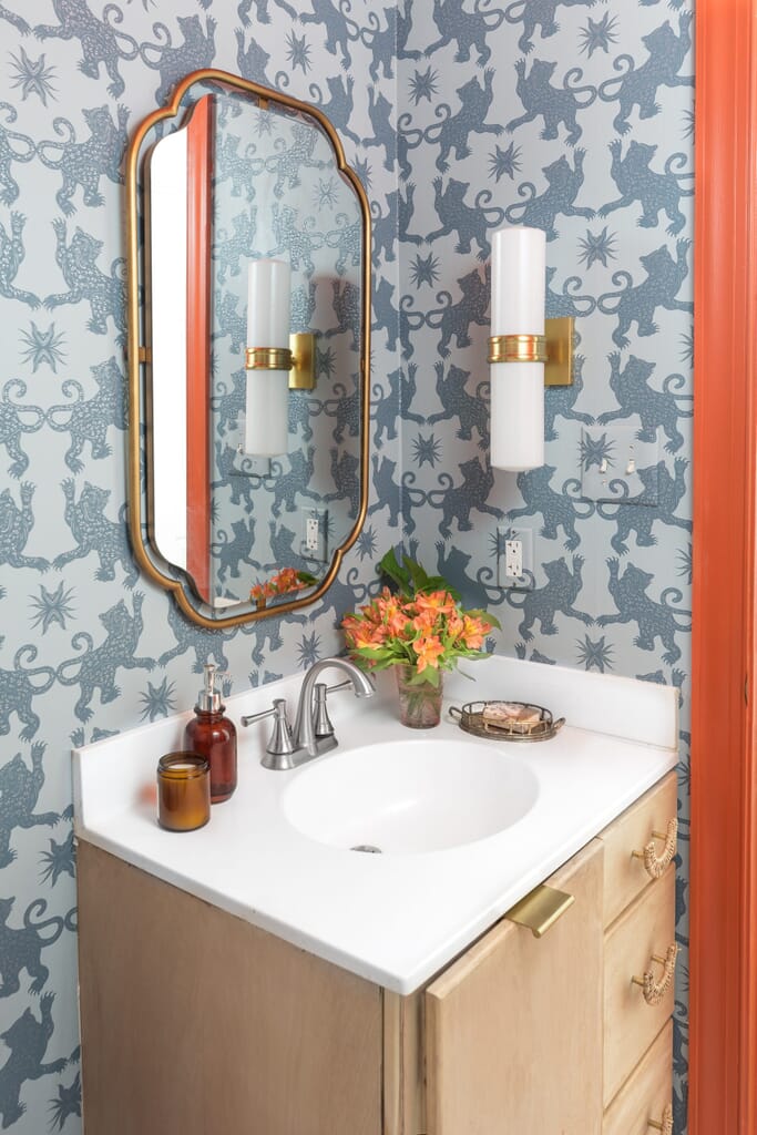 Maximalism in a powder room with patterned wallpaper and Art Deco inspired fixtures. Maximalism Design: How to Add Bold Style to Your Home - LightsOnline Blog
