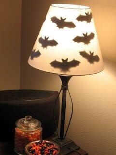 Bat shapes taped inside a lampshade create a fun Halloween look. Learn more on LightsOnline.com Blog.