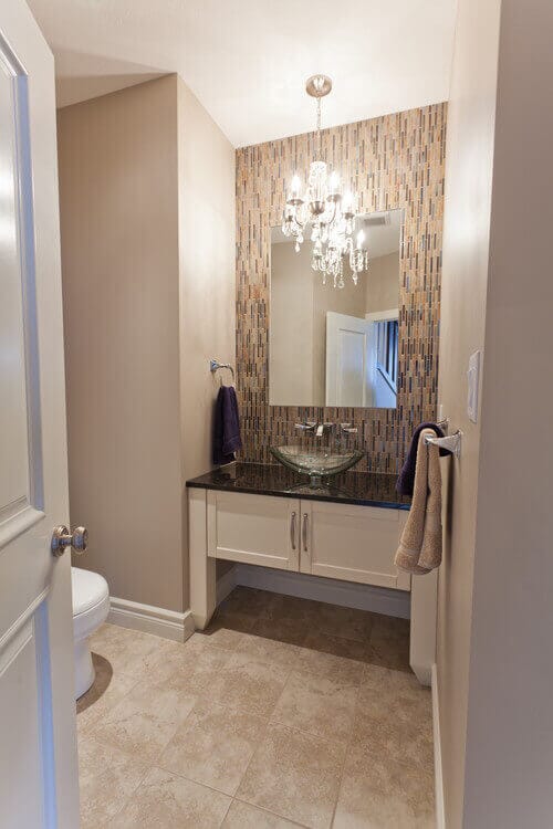 A mini chandelier like the ones offered by Minka Lavery are a great way to get shimmer and shine in a powder room. Photo credit: Contemporary Powder Room by Lethbridge Home Builders Galko Homes