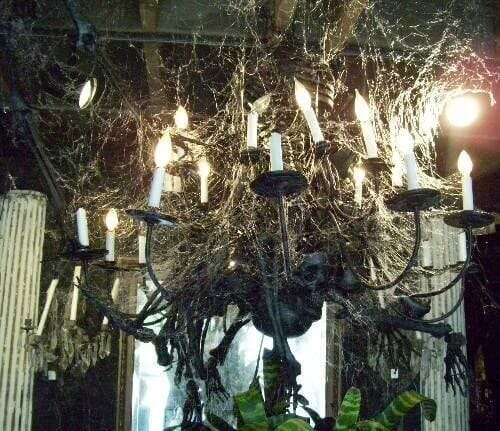 Artfully drape spider webbing on a chandelier for a spooky cool Halloween look. Read more on LightsOnline.com Blog.