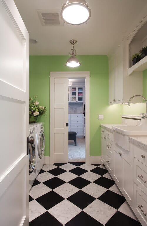 No-nonsense industrial style lights are great for laundry rooms. Photo credit: Traditional Laundry Room by Kirkland Interior Designers & Decorators Kristi Spouse Interiors
