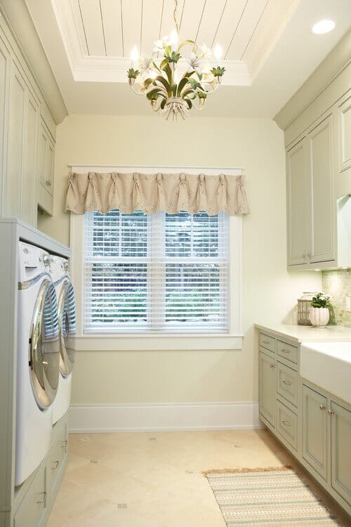 Make your laundry room shine with a pretty chandelier. Photo credit: Traditional Laundry Room by Grand Rapids Architects & Designers Sears Architects